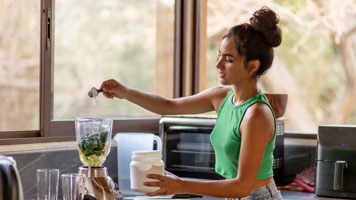 A woman making protein shakes